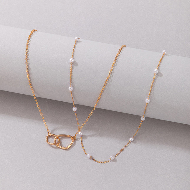 Collar doble de cadena de perlas con cruz geométrica